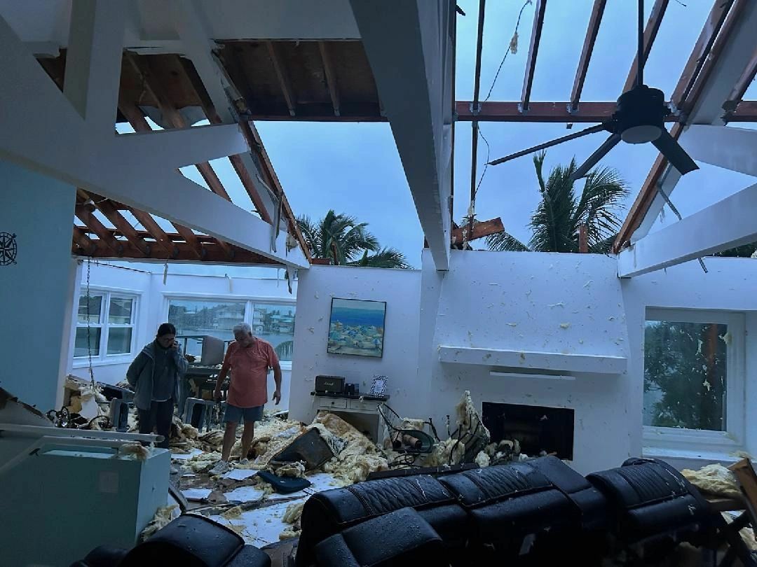 A living room open to the sky after Hurricane Milton tore away the roof